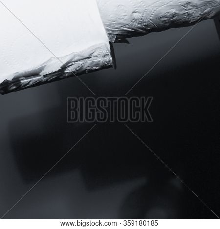 Dramatic Close Up Of Toilet Paper Supply