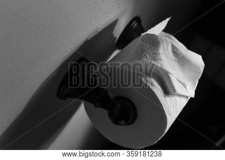 Dramatic Close Up Of Toilet Paper Supply