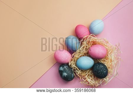 Painted Colorful Easter Eggs And Gift On Pink And Yellowbackground And Frame For Text