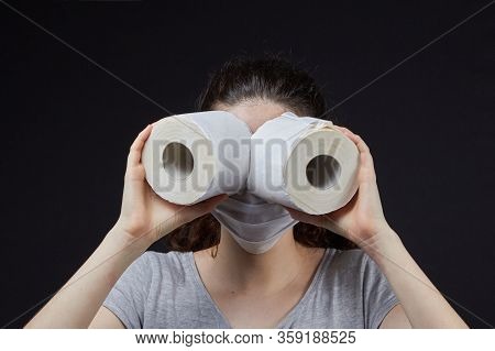 Young Girl In A Mask In A Panic Buys Toilet Paper