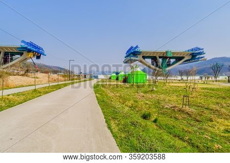 Sejong, South Korea; April 1, 2020: Landscape Of Public Park With Green Tents Near Sidewalk And Side