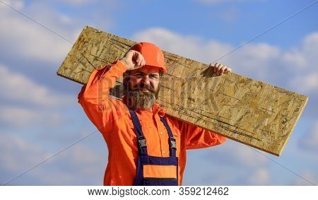 Assemble Temporary Equipment Or Structures. Renovation Services. Man Carry Fiberboard. Engineered Wo