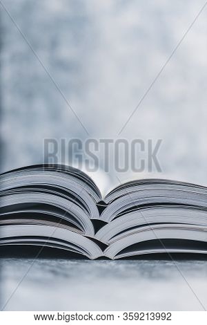 Education And Self-improvement, Pile Of Open Books Shot From Eye Level With Shallow Depth Of Field