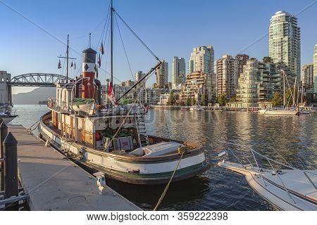 An Old Steam Boat And High Rises Buildings From Granville Island Bc Canada.