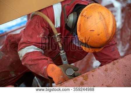 Process Of Derusting, Paint And Rust Removal By Pneumatic Chisel From Ship Deck By Vessel Crew.