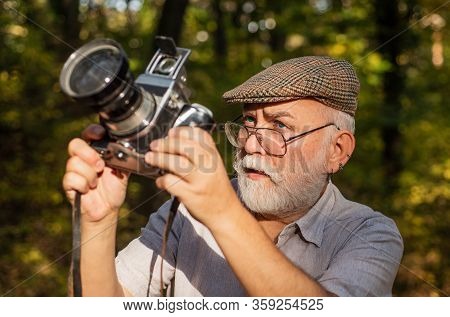 Pension Hobby. Experienced Photographer. Vintage Camera. Old Man Shoot Nature. Professional Photogra