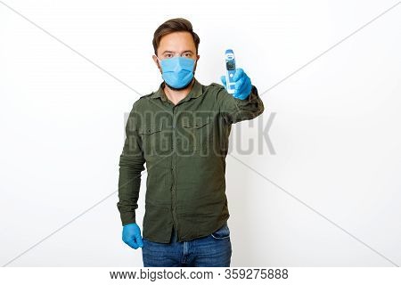 A Male Person Being Measured Body Temperature With A Contactless Thermometer And Shows The Dial 36.6
