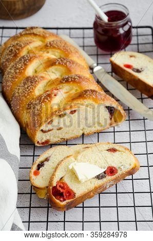 Traditional Sweet Easter Bread With Raisins, Dried Cherries With Jam And Butter On A Light Backgroun