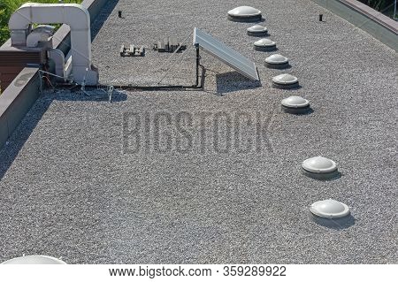 Solar Cells And Skylight Windows At Gravel Flat Roof