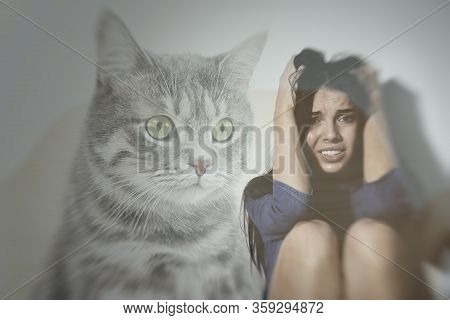 Woman Suffering From Ailurophobia On White Background. Irrational Fear Of Cats