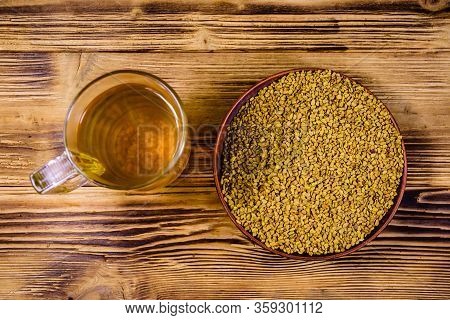 Cup Of Yellow Tea (methi Dana) And Plate With Fenugreek Seeds On Rustic Wooden Table. Top View
