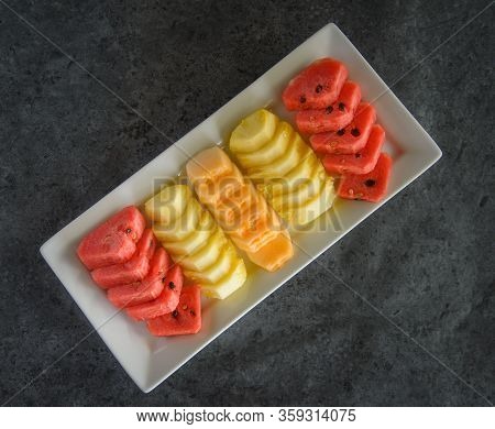 Sliced Fruit On Dish, Pineapple And Watermalon And Melon.