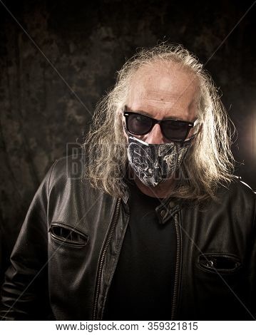 Portrait Of A Long Haired Biker Wearing Leather Jacket And Sunglasses , Looking At Viewer Wearing Sa
