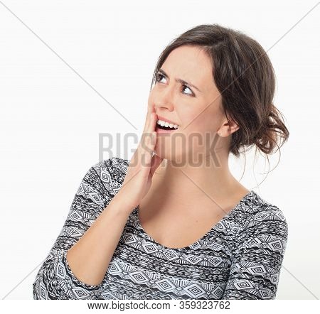 Excited Young Woman Keeping Her Arm To Mouth