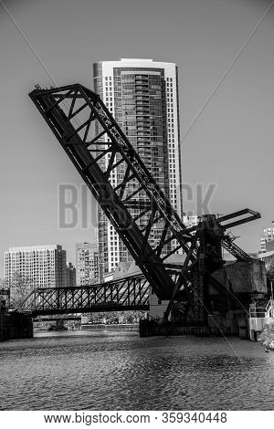One Of The Many Bridges That Crosses The River In Chicago In Black And White