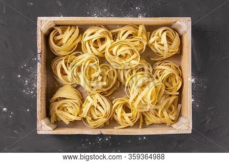 Raw Tagliatelle In A Wooden Box. Top Views
