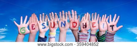 Kids Hands Holding Word Gesundheit Means Health, Blue Sky