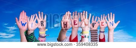 Kids Hands Holding Word Wir Helfen Means We Help, Blue Sky