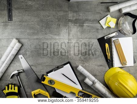 Contractor Concept. Tool Kit Of The Contractor: Yellow Hardhat, Libella, Hand Saw. Plans And Noteboo