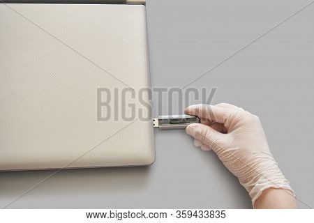 Hand In White Glove Insert Usb Flash Disc At Lattop. Anti Virus Protect Concept. Medical Home Hygien