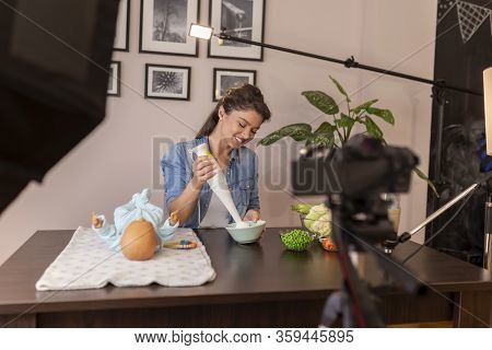 Vlogger Filming Video About Introducing Soft Food To Baby Nutrition And Preparation Of Fresh Fruit A
