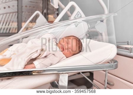 Newborn Baby Sleeping In The Hospital Bed