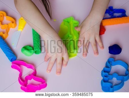 Child Hands Playing With Colorful Clay. Homemade Plastiline. Girl Molding Modeling Clay. Homemade Cl