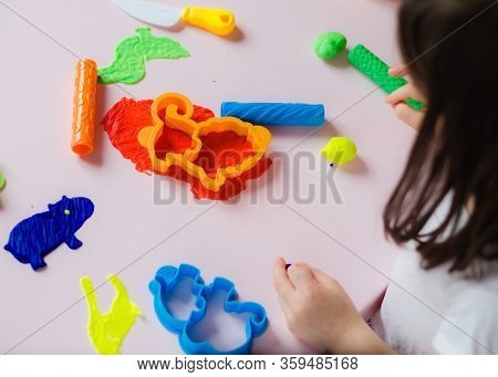 Child Hands Playing With Colorful Clay. Homemade Plastiline. Girl Molding Modeling Clay. Homemade Cl