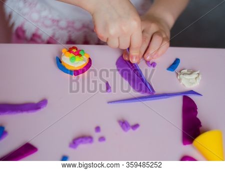 Child Hands Playing With Colorful Clay. Homemade Plastiline. Girl Molding Modeling Clay. Homemade Cl