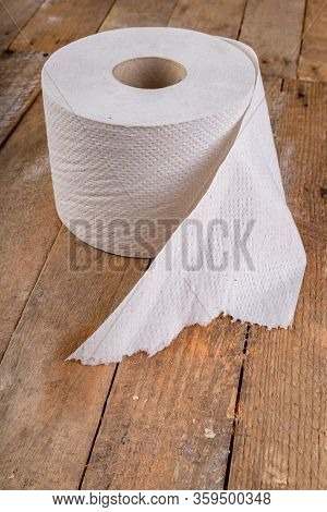 Toilet Paper On An Old Wooden Table. Hygienic Items In The Workshop.
