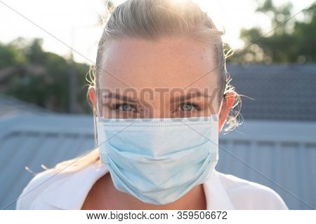 Portrait of woman in protective mask against flu and viruses outdoors. Helathcare, flu epidemic, dust allergy, virus protection, air pollution concept