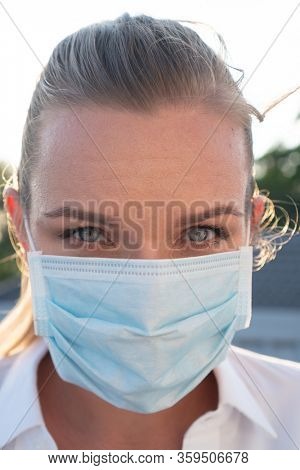 Portrait of woman in protective mask against flu and viruses outdoors. Helathcare, flu epidemic, dust allergy, virus protection, air pollution concept