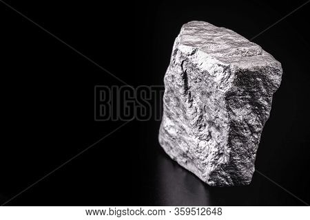 Raw Manganese. Manganese Stone Isolated On Black Background. Mineral Extraction Of Heavy Metals.