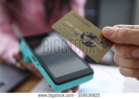 Man Holds Credit Card With Paypass Technology. Overdraft Debit Card. Making Transfers. Portable Term
