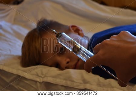 Vaccination Of The Child. Big Scary Syringe. Frightening Doctor . Mandatory Vaccination Of Children.