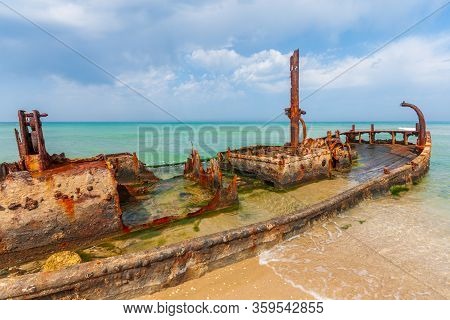 View Of A Rusty Shipwreck On The Beach. Habonim Shore, Israel