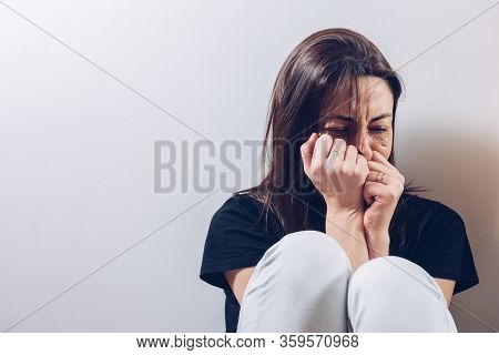 Attractive Young Woman, Takes Her Clenched Fists To Her Injured Face To Cover Herself While She Crie