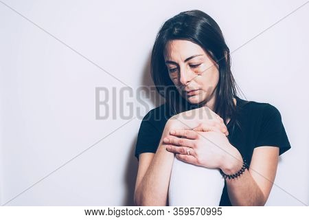 Woman Sitting On The Floor With Her Knee Bent Looks At The Ground Looking For An Explanation For The
