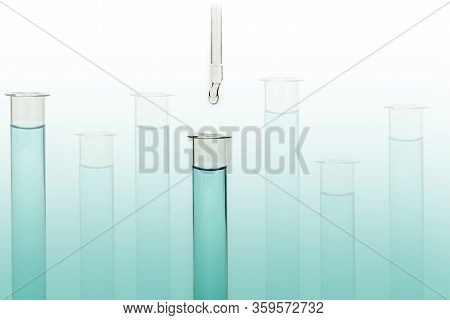 Dripping Reagent Into Test Tube With Liquid Sample