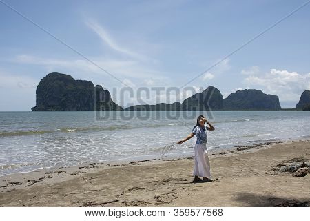 Traveler Thai Women Relax On The Beach And Portrait Posing For Take Photo With Wave Water Of Sea And