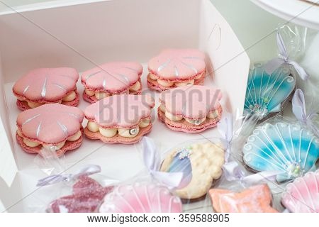Mermaid Theme Candy Bar With Cake, Cupcakes, Macaroons And Biscuits. Sea Shell Shaped Macaroons With