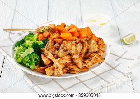 Low-fat Chicken Breast And Veggies With Sweet Potato And Boiled Broccoli On A White Plate On A White