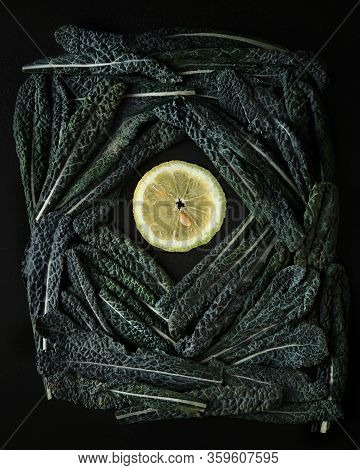 Green Tuskan Kale Leaves End Lemon Slices On A Dark Background. Healthy Detox Vegetables . Clean Eat