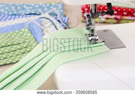 Sewing Reusable Fabric Masks At Home For Coronavirus Protection. Multi-colored Fabric Reusable Prote