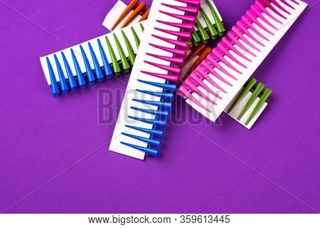 On A Purple Background Hair Clips Of Different Colors In Sets On A Cardboard Frame