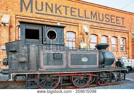 Eskilstuna, Sweden - October 23, 2015: Outdoor Closeup Of An Old Black Locomotive In Front Of The En
