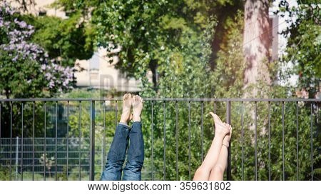 Legs Barefoot Sunbathing On The Balcony. 16:9 Panoramic Format. Sunny Day