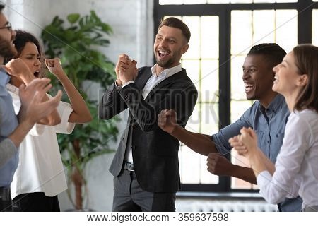 Happy Businessman With Team Celebrate Corporate Victory Together In Office.