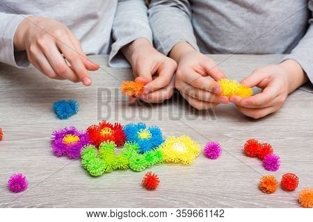 Children Add Details Of Colored Sticky Mosaics Into A Drawing Of Flowers On The Table. Leisure Of Th