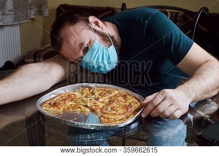 Man Bites Of Pizza With His Mouth Wide Open. A Hungry Person.